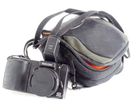 A Ricoh GX200 camera, 12cm wide, with carry case, instruction manuals and other accessories (a quantity).