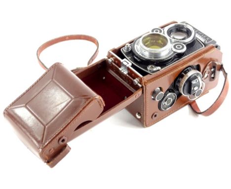 A Rolleiflex reflex camera, with German Franke &amp; Heidecke lens in leather travelling case.