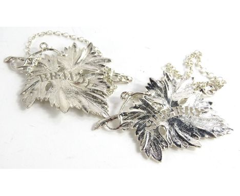 A pair of Elizabeth II cast silver decanter labels, modelled as vine leaves, with pierced names for sherry and brandy, Birmin
