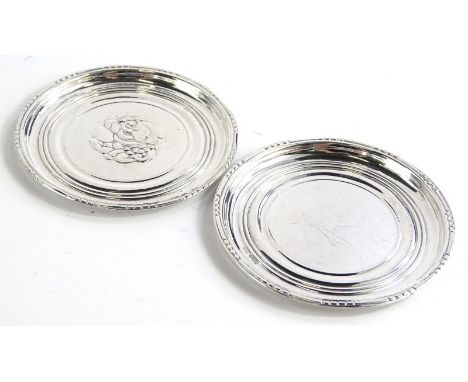 A pair of Georg Jensen silver dishes, each decorated with fruit on a hammered ground, with beaded borders, stamped GJ Limited