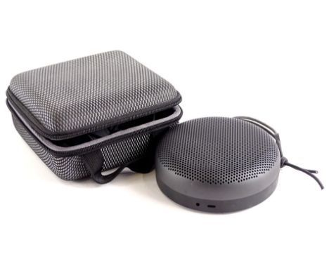 A Bang &amp; Olufsen Beoplay 41 bluetooth speaker, of circular form, 13cm diameter, with wire and outer case.