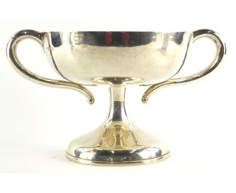 An Edwardian silver two handled cup, with shaped handles, waisted column, and domed foot, unengraved, Chester 1908, 23¼ oz, 2