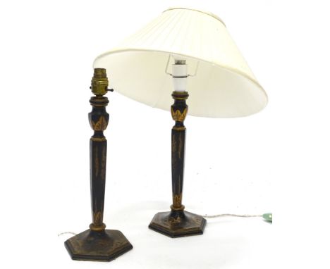 A pair of early 20thC black Japanned lamp bases, each decorated with buildings, flowers, etc., in gilt raised lacquer work, 4