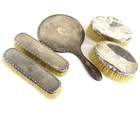 Various silver mounted dressing table items, to include an engine turned hand mirror, lacking mirror plate, and various brush