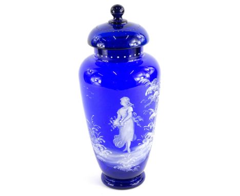 An early 20thC Bristol blue type Mary Gregory design jar and cover, with a dot decoration, set with a figure holding basket, 