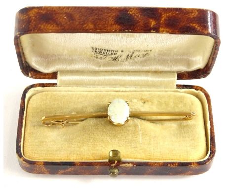 An opal 9ct gold bar brooch, set with single oval opal, in four claw setting, on a plain pin, 5.5cm long, 2.4g all in, boxed.