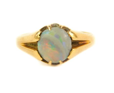 An 18ct gold dress ring, set with a single opal, Birmingham assay, 3.7g all in.