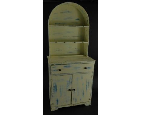 A miniature child's Dutch style dresser, with arched plate rack, frieze drawer and two cupboard doors on bracket feet, 33cm h
