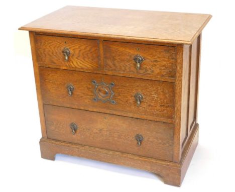A 1920s oak chest of drawers, the top with moulded edge with two short and three long drawers, each with brass tier drop hand