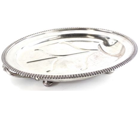 An early 20thC Elkington and Co warming silver plated meat dish, with a gadrooned border, two cast handles on bun feet, 61.5c