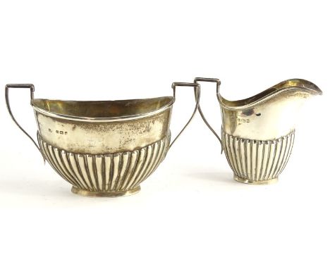 A George V silver part fluted two handled sugar bowl, and a matching milk jug, Birmingham 1910, 4½oz.