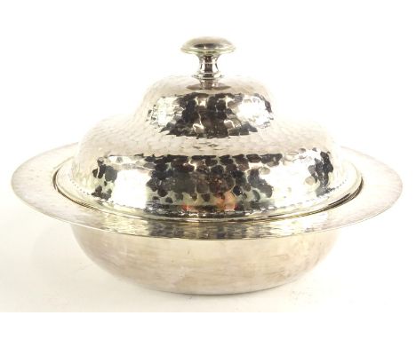 An Arts and Crafts silver plated muffin dish, with overall hammered decoration, makers stamp to underside of J.C. and Co Limi