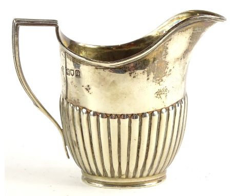 A George V silver part fluted cream jug, with a reeded border and anchored handle, London 1911, 4¾oz.