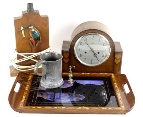 A South American parquetry tray, with inset design using butterfly wings, an oak mantel clock, a lamp base carved and painted