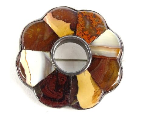 A Celtic design circular brooch, set with various semi precious stones, in a white metal frame, unmarked, 5cm wide.