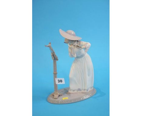 A boxed Lladro figure of a girl playing an flute