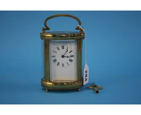 An oval brass carriage clock