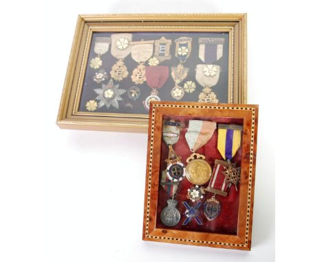 FRAMED AND GLAZED COLLECTION OF GILT METAL AND MAINLY YELLOW ENAMEL MEDALLIONS AND BADGES RELATING TO THE PRIMROSE LEAGUE inc