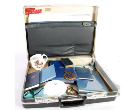 COLLECTION OF MASONIC REGALIA including;  TWO APRONS, SASH, BOOKS, MUG, HORSE BRASS, etc... (contents of a briefcase)   