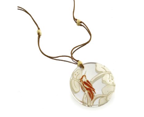 Marcel Goupy, an enamelled glass pendant on necklace, circa 1925, circular lens form painted with a bird on branch, in oraneg