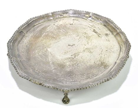EDWARD BARNARD &amp; SONS LTD; a George V hallmarked silver waiter of circular form with cast rim on four pad feet, London 19