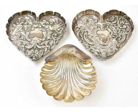 WILLIAM COMYNS; a matched pair of hallmarked silver heart shaped trinket dishes, London 1912 and 1916, and a late Victorian s