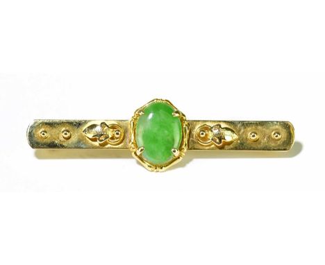A Chinese 14ct yellow gold bar brooch centred with an oval jade plaque, length 45mm, approx. 5.1g.Condition Report: The jade 