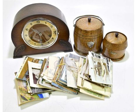 An early 20th century oak mantel clock, the silver dial set with Arabic numerals, together with an oak biscuit barrel and sim