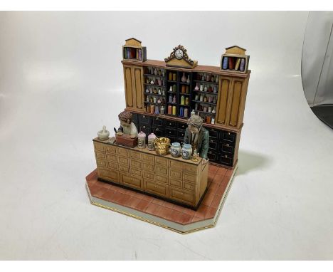 R. GUIDOLIN FOR CAPODIMONTE; a large ceramic sculpture in two pieces depicting figures in an apothecary shop.