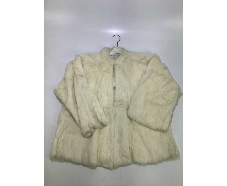 A 1950’s vintage short cream rabbit fur jacket lined with cream silk, with fasteners to front, small collar and 3/4 length sl
