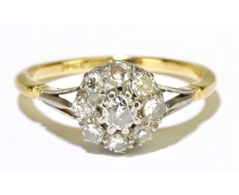 An 18ct yellow gold platinum tipped diamond floral set ring, the central raised stone approx. 0.20cts, within a border of eig