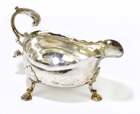 JAMES MORISON; a George II hallmarked silver sauce boat with double C-scroll handle, shaped rim, and three stepped hoof suppo