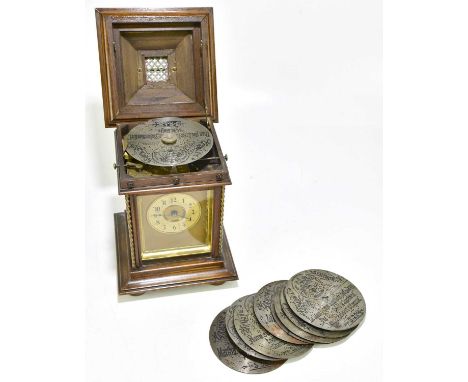 A 19th century German stained beech musical mantel clock, the hinged cover enclosing Harmonie/Symphonion disc, with the circu
