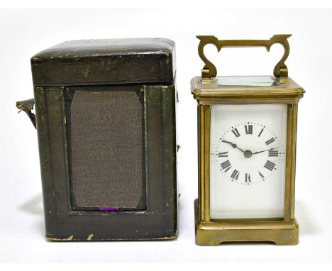 A 19th century French brass cased carriage clock, the enamalled dial set with Roman numerals, height including swing handle 1