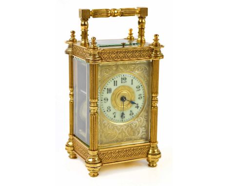 A 19th century French brass cased repeating carriage clock, with filigree decoration to the case and face, the circular dial 