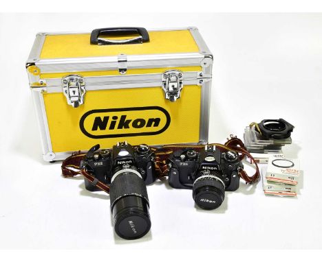 NIKON; a travelling case containing two FE2 cameras, one equipped with Hakuba UV 62mm lens, together with an assortment of ca