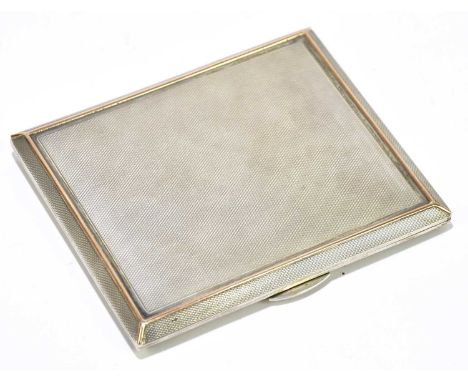 A George VI hallmarked silver and gold trimmed engine turned rectangular cigarette case, Birmingham 1950, 10.25 x 8.75cm, app