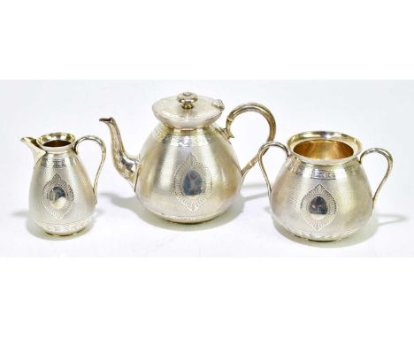 S SMITH & SON; a Victorian hallmarked silver three piece tea service with gilded interior and engine turned decoration surrou