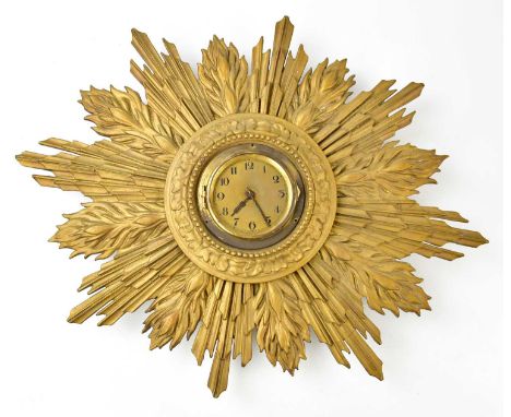 An Art Deco gilt plaster sunburst wall clock, the dial set with Arabic numerals, width 55cm.