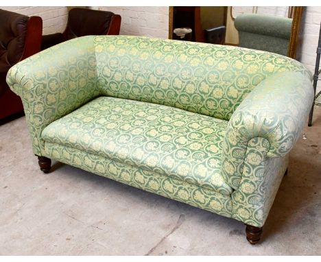 A Victorian drop end Chesterfield type sofa, upholstered in a floral green material, on turned column supports, width 166cm, 