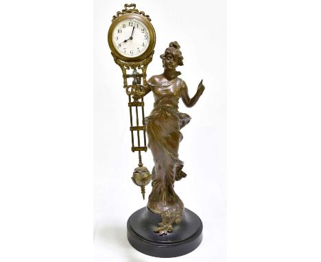 A circa 1900 spelter mystery clock with female figure holding the balancing timepiece and with Arabic numerals to the white e