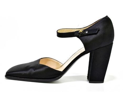 CHANEL; a pair of black satin shoes with square toe detail and bar strap with black button with CC gold tone logo, lined with