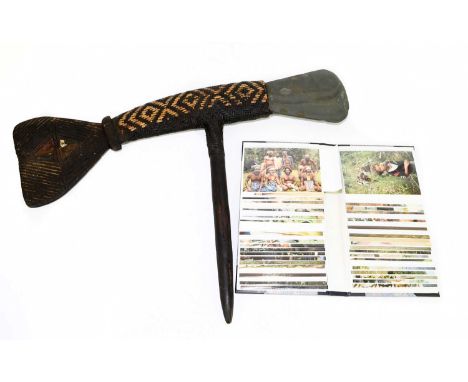 PAPUA NEW GUINEA; a carved wood and wicker double sided axe, height 47cm, length 53cm, together with a photograph album of va