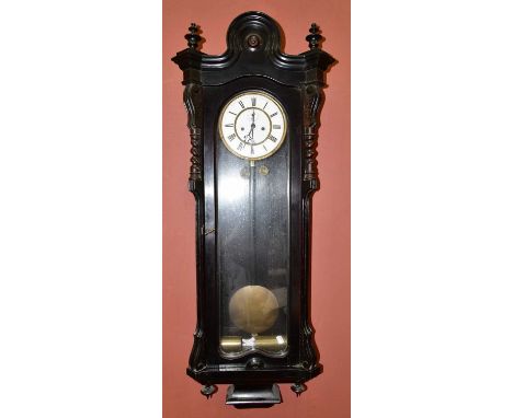 A 19th century ebonised Vienna style wall clock with arched mount, the enamelled dial set with Roman numerals and subsidiary 