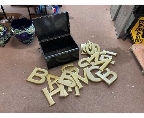 A collection fairground letters in a black tin trunk.