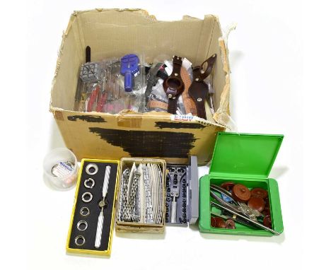 A large collection of watch parts, straps, and watch making equipment and tools. 
