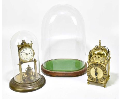 A brass anniversary clock, the dial set with Arabic numerals, within a glass dome, height 30cm, together with a modern brass 