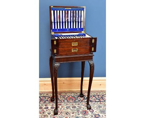 A mahogany canteen on stand with hinged cover and two drawers containing of silver plated cutlery and flatware, height 102cm.