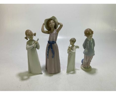 LLADRO; three ceramic figures to include a girl wearing a pink dress with a blue bow holding a bonnet hat, height 25cm, also 