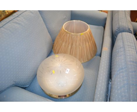 A large glass light fitting and a lamp shade 